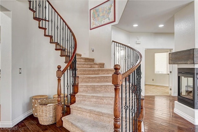 1717 Jake Andrew Ave, North Las Vegas, NV 89086 - stairs with wood finished floors, recessed lighting, and a multi sided fireplace