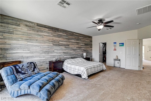1717 Jake Andrew Ave, North Las Vegas, NV 89086 - carpeted bedroom featuring an accent wall, ceiling fan, a walk in closet, wood walls, and a closet