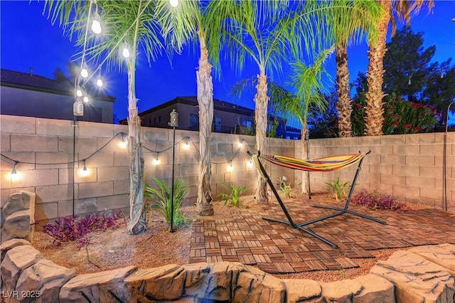 1717 Jake Andrew Ave, North Las Vegas, NV 89086 - patio at night featuring a fenced backyard and a patio