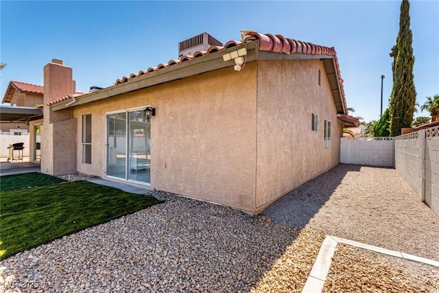 3826 Edmond St, Las Vegas, NV 89103 - view of property exterior with a fenced backyard, stucco siding, a patio, and a tiled roof