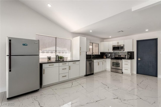3826 Edmond St, Las Vegas, NV 89103 - kitchen featuring appliances with stainless steel finishes, dark countertops, backsplash, white cabinetry, and recessed lighting