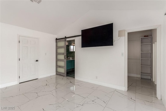 3826 Edmond St, Las Vegas, NV 89103 - unfurnished bedroom featuring lofted ceiling, a spacious closet, light marble finish floors, connected bathroom, and a barn door