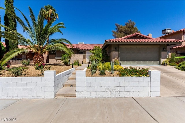 3826 Edmond St, Las Vegas, NV 89103 - mediterranean / spanish-style home with driveway, a tiled roof, stucco siding, and a garage