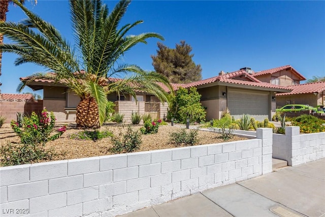 3826 Edmond St, Las Vegas, NV 89103 - view of front of house with stucco siding, an attached garage, a tiled roof, and concrete driveway