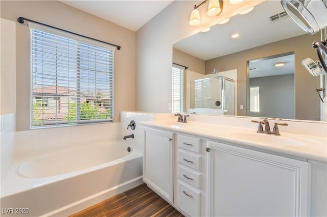11901 Luna Del Mar Ln, Las Vegas, NV 89138 - bathroom with a bath, double vanity, a stall shower, and wood finished floors