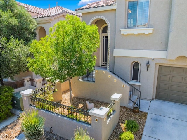 11901 Luna Del Mar Ln, Las Vegas, NV 89138 - view of front of house featuring a fenced front yard, stucco siding, a garage, and a tile roof