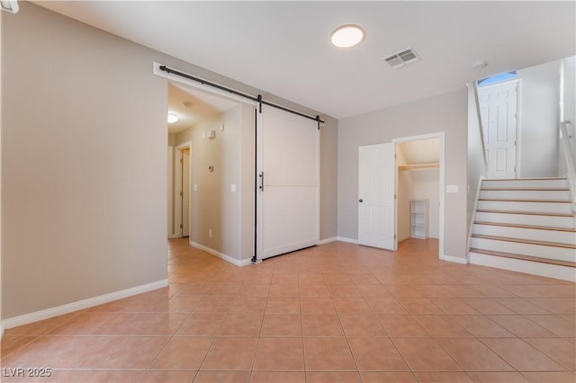 11901 Luna Del Mar Ln, Las Vegas, NV 89138 - unfurnished living room with a barn door, light tile patterned floors, and stairs