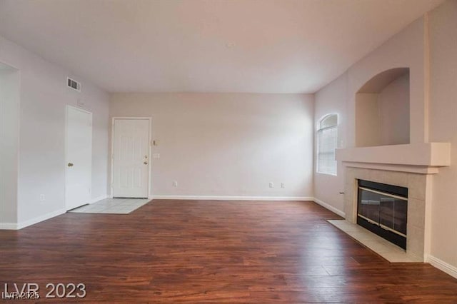5415 W Harmon Ave Unit 1162, Las Vegas, NV 89103 - unfurnished living room featuring wood finished floors and a tile fireplace