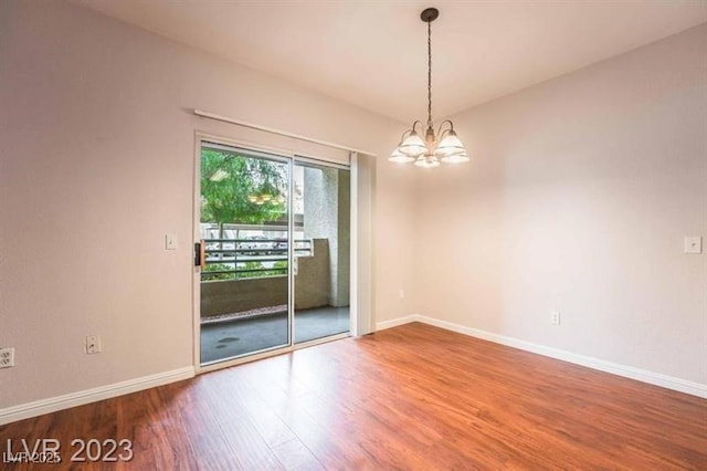 5415 W Harmon Ave Unit 1162, Las Vegas, NV 89103 - empty room with a chandelier and wood finished floors