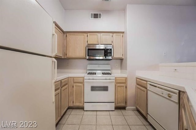 5415 W Harmon Ave Unit 1162, Las Vegas, NV 89103 - kitchen with white appliances, light tile patterned floors, and tile counters