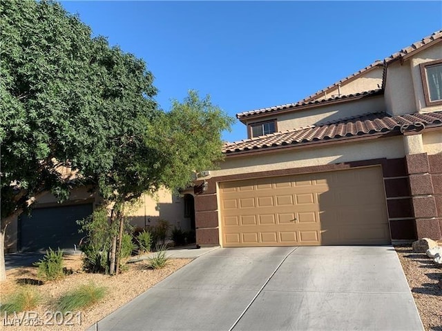 3813 Juanita May Ave, North Las Vegas, NV 89032 - view of front facade with concrete driveway, stucco siding, a garage, and a tiled roof