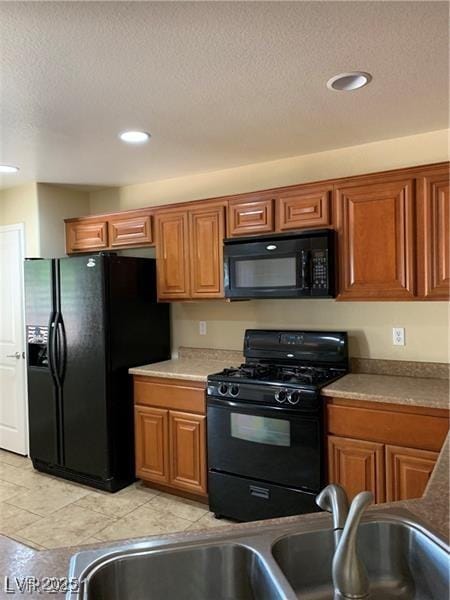 3813 Juanita May Ave, North Las Vegas, NV 89032 - kitchen featuring black appliances, brown cabinetry, a textured ceiling, recessed lighting, and light countertops