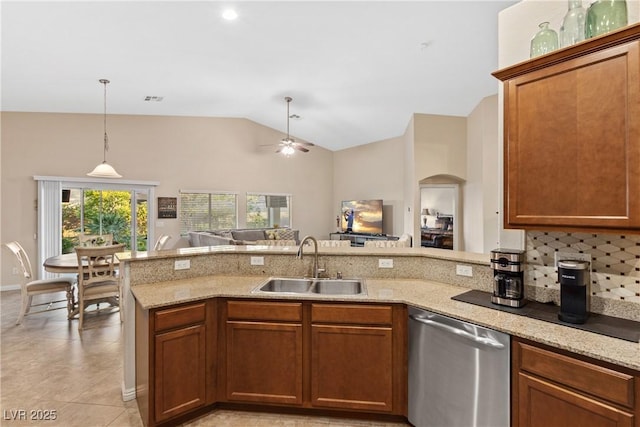 6413 White Tiger Ct, Las Vegas, NV 89130 - kitchen with stainless steel dishwasher, ceiling fan, vaulted ceiling, light stone countertops, and a peninsula