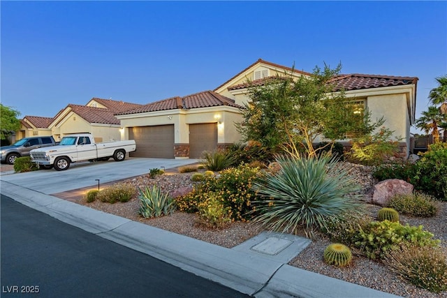 6413 White Tiger Ct, Las Vegas, NV 89130 - view of front of house featuring a tile roof, an attached garage, stucco siding, concrete driveway, and stone siding
