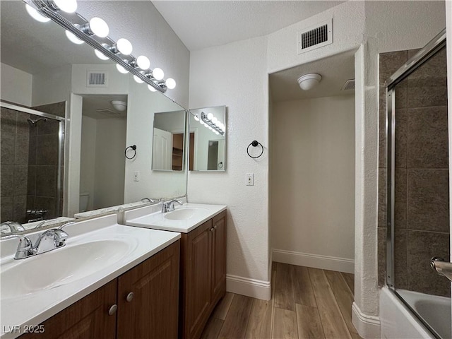453 Las Casitas Way, Las Vegas, NV 89121 - bathroom featuring vanity, wood finished floors, and enclosed tub / shower combo