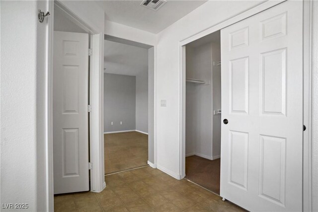 7263 Pepperbox Ave, Las Vegas, NV 89179 - hallway featuring light carpet and baseboards