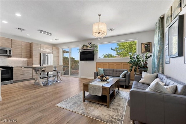 694 Value Ridge Ave, Henderson, NV 89012 - living room with a chandelier, light wood-type flooring, and recessed lighting