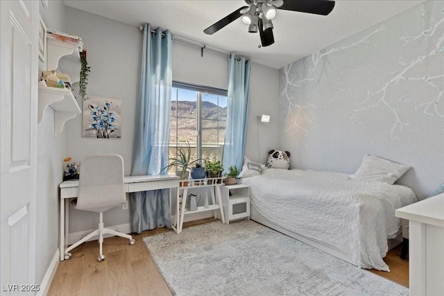 694 Value Ridge Ave, Henderson, NV 89012 - bedroom with wood finished floors, a desk, and ceiling fan