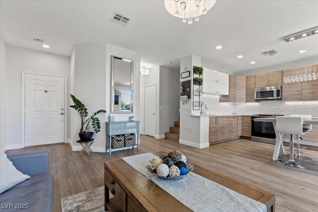 694 Value Ridge Ave, Henderson, NV 89012 - living room featuring light wood-style flooring and recessed lighting