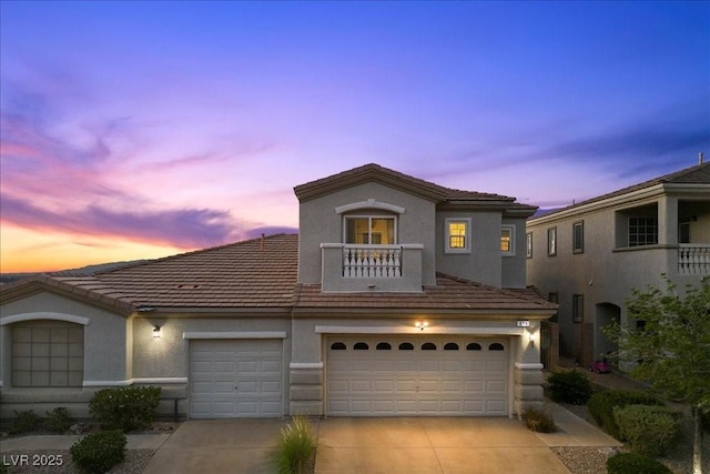 694 Value Ridge Ave, Henderson, NV 89012 - mediterranean / spanish-style home featuring driveway, a balcony, an attached garage, and stucco siding