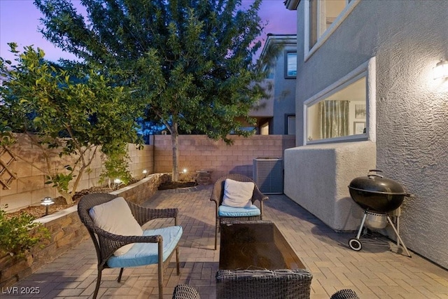 694 Value Ridge Ave, Henderson, NV 89012 - patio terrace at dusk with a fenced backyard, a patio, and a grill