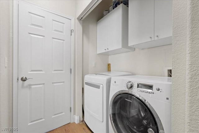 694 Value Ridge Ave, Henderson, NV 89012 - laundry area featuring washer and dryer, cabinet space, and light wood-style floors