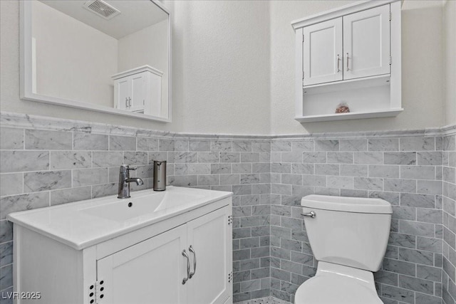 694 Value Ridge Ave, Henderson, NV 89012 - half bathroom with tile walls, vanity, and a wainscoted wall
