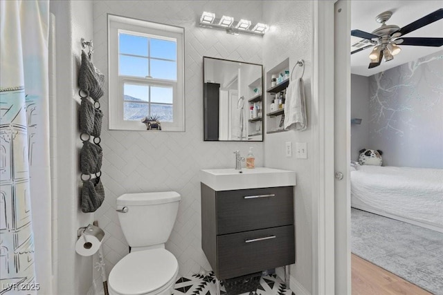 694 Value Ridge Ave, Henderson, NV 89012 - bathroom featuring vanity, ceiling fan, wood finished floors, and connected bathroom