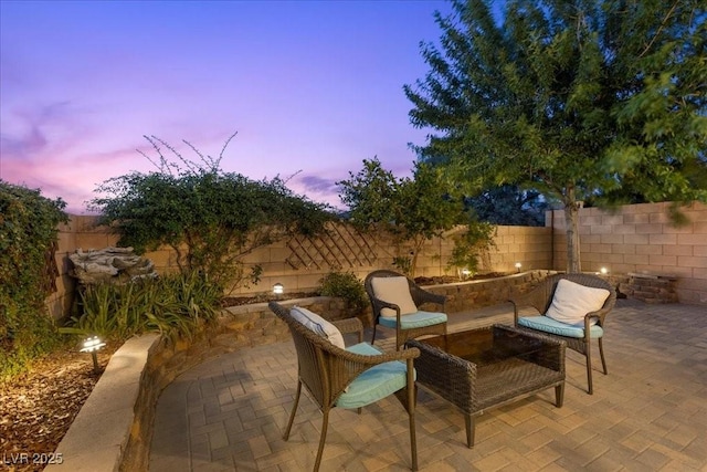 694 Value Ridge Ave, Henderson, NV 89012 - patio terrace at dusk featuring a fenced backyard and a patio