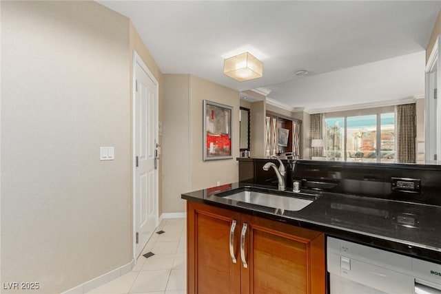135 E Harmon Ave Unit 2702, Las Vegas, NV 89109 - kitchen with white dishwasher, brown cabinets, light tile patterned floors, and dark stone counters