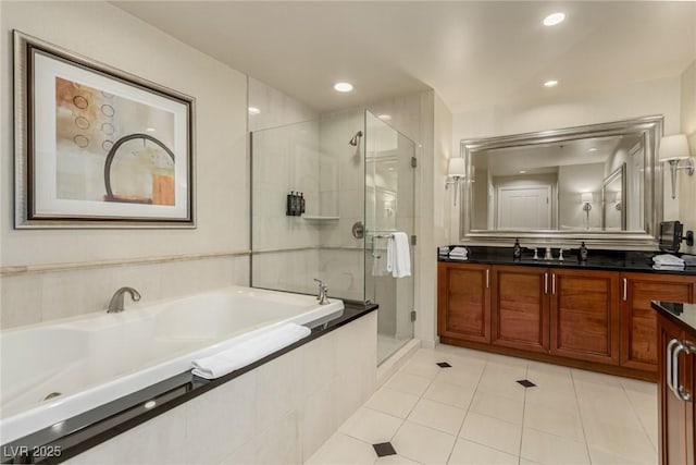 135 E Harmon Ave Unit 2702, Las Vegas, NV 89109 - bathroom with vanity, a shower stall, a garden tub, tile patterned flooring, and recessed lighting
