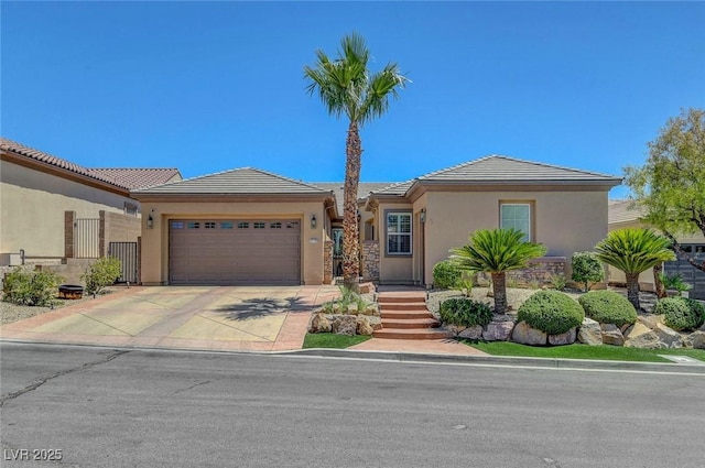 2779 Kindeace Ave, Henderson, NV 89044 - ranch-style house with an attached garage, stucco siding, concrete driveway, and a tiled roof