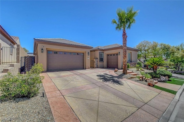 2779 Kindeace Ave, Henderson, NV 89044 - view of front facade featuring stucco siding, a garage, and driveway