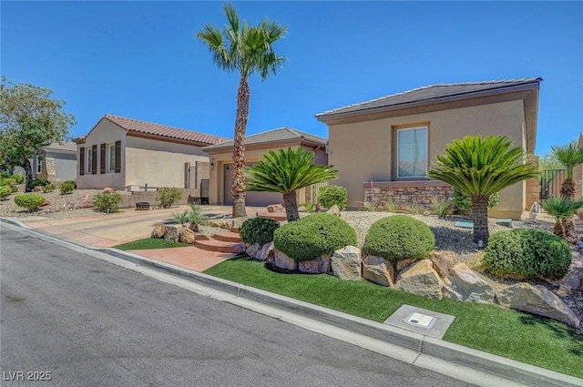 2779 Kindeace Ave, Henderson, NV 89044 - view of front of home featuring stucco siding, an attached garage, a tile roof, and driveway