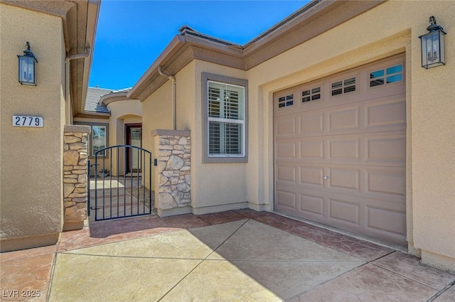 2779 Kindeace Ave, Henderson, NV 89044 - entrance to property featuring stucco siding, a gate, and stone siding