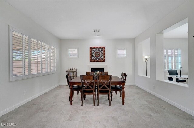 2779 Kindeace Ave, Henderson, NV 89044 - dining area with healthy amount of natural light and a fireplace