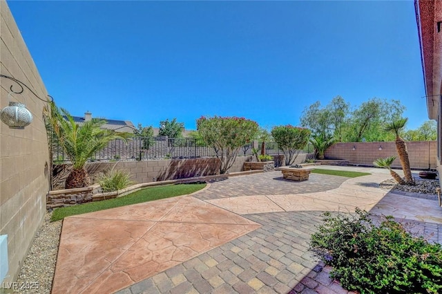 2779 Kindeace Ave, Henderson, NV 89044 - fenced backyard with a patio area and an outdoor fire pit