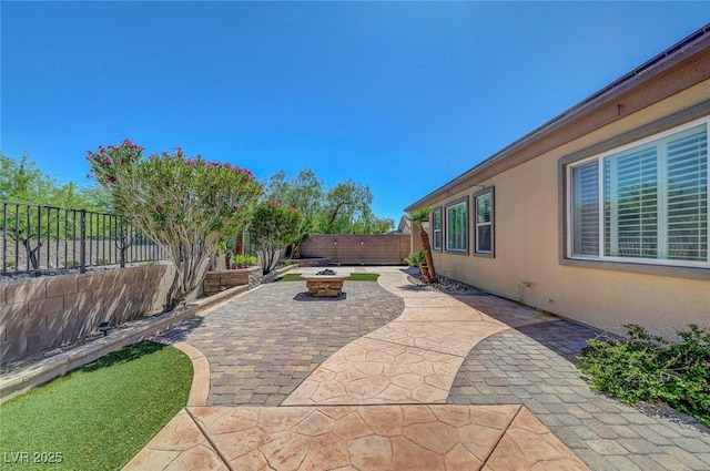 2779 Kindeace Ave, Henderson, NV 89044 - fenced backyard with a fire pit and a patio