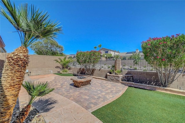 2779 Kindeace Ave, Henderson, NV 89044 - fenced backyard with a fire pit and a patio area
