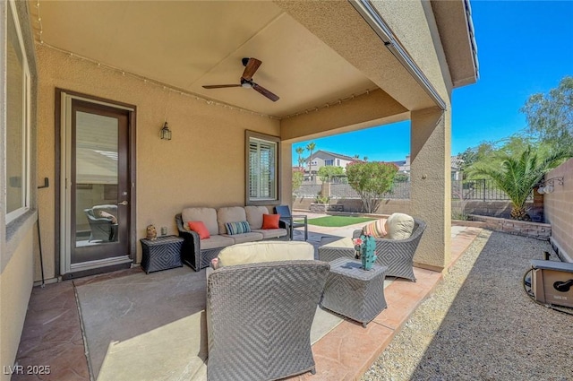 2779 Kindeace Ave, Henderson, NV 89044 - fenced backyard featuring an outdoor hangout area, a patio, and a ceiling fan