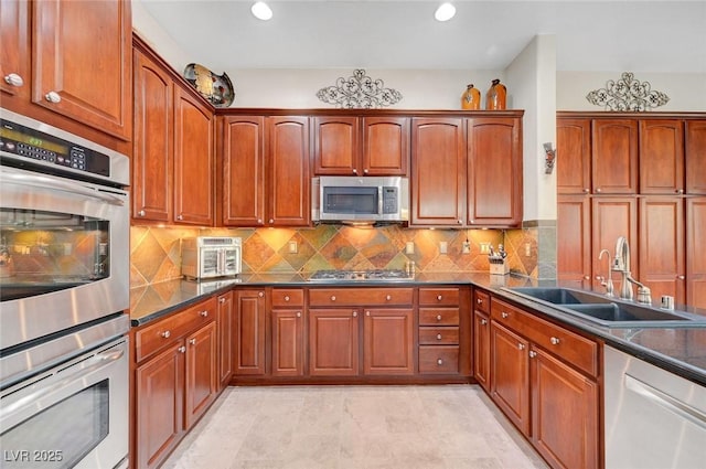 2779 Kindeace Ave, Henderson, NV 89044 - kitchen with stainless steel appliances, dark countertops, tasteful backsplash, brown cabinetry, and recessed lighting