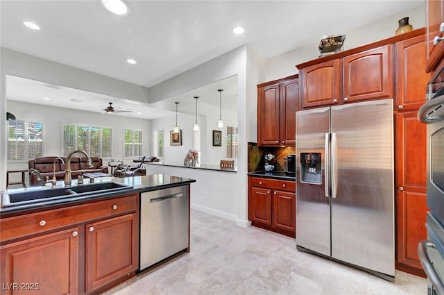 2779 Kindeace Ave, Henderson, NV 89044 - kitchen with appliances with stainless steel finishes, dark countertops, ceiling fan, recessed lighting, and tasteful backsplash