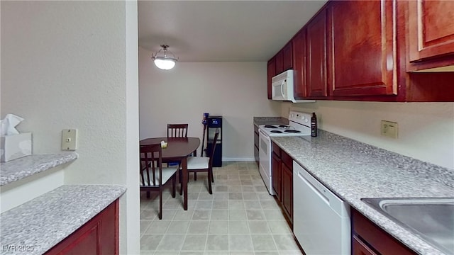 4990 River Glen Dr Unit 171, Las Vegas, NV 89103 - kitchen with white appliances, dark brown cabinets, and light countertops