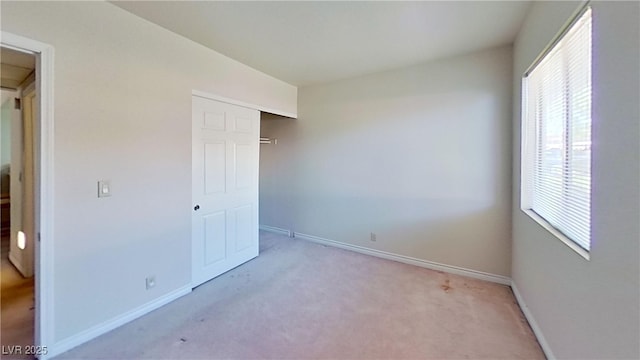 4990 River Glen Dr Unit 171, Las Vegas, NV 89103 - unfurnished bedroom featuring multiple windows and light colored carpet