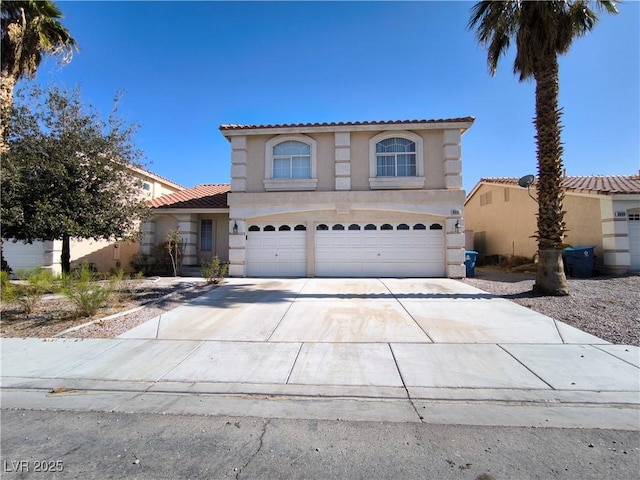 9693 Bighorn Island Ave, Las Vegas, NV 89148 - mediterranean / spanish-style home featuring a garage, stucco siding, and concrete driveway