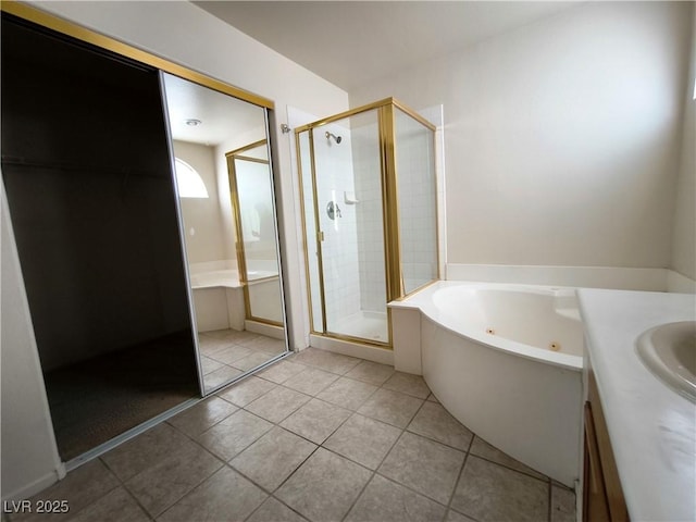 9693 Bighorn Island Ave, Las Vegas, NV 89148 - bathroom with a tub with jets, a stall shower, tile patterned flooring, and vanity
