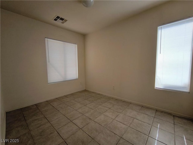 9693 Bighorn Island Ave, Las Vegas, NV 89148 - spare room featuring light tile patterned floors and baseboards