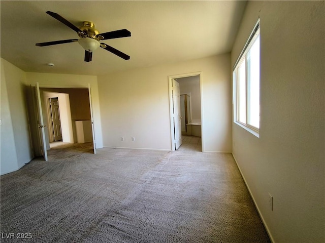 9693 Bighorn Island Ave, Las Vegas, NV 89148 - unfurnished bedroom with light colored carpet, ensuite bath, and a ceiling fan
