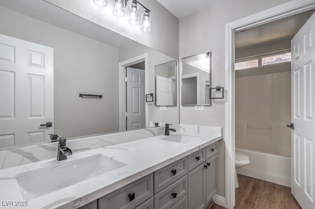 7619 Comanche Canyon Ave, Las Vegas, NV 89113 - bathroom with double vanity, wood finished floors, and shower / bath combination