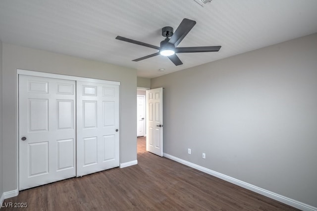 7619 Comanche Canyon Ave, Las Vegas, NV 89113 - unfurnished bedroom with dark wood-style floors, a closet, and a ceiling fan